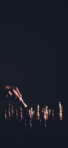Hand playing chess background